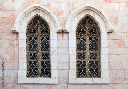 Intricate gothic windows design on historic stone building facade