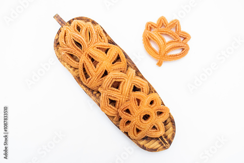 Nakshi pitha biscuit served on wooden board isolated on white background top view of indian, pakistani and bangladeshi food photo