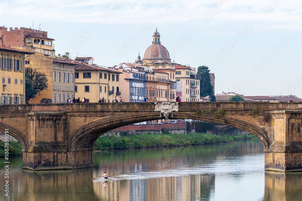 Florence, Italy - November 5, 2024: Cityscape of the city. Bridge over the river with historical city buildings in the background. Florence, Italy - November 5, 2024: Cityscape of the city. Bridge over the river with historical city buildings in the background.