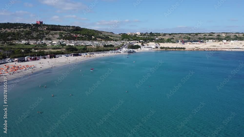 Malta Aerial, white sand beach with umbrelas in November. Approaching roundabout near Ghadira Nature reserve. High quality 4k footage Malta Aerial, white sand beach with umbrelas in November. Approaching roundabout near Ghadira Nature reserve. High quality 4k footage
