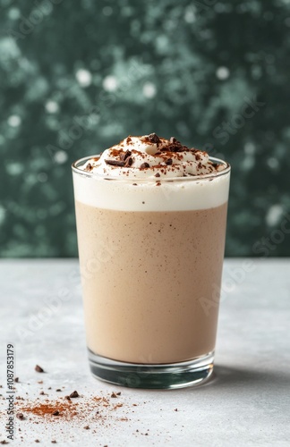 Creamy coffee drink with whipped cream and chocolate shavings on a gray backg...