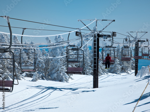 Skiers on a chairlift at the Shibutoge ski area, Nagano, Japan photo