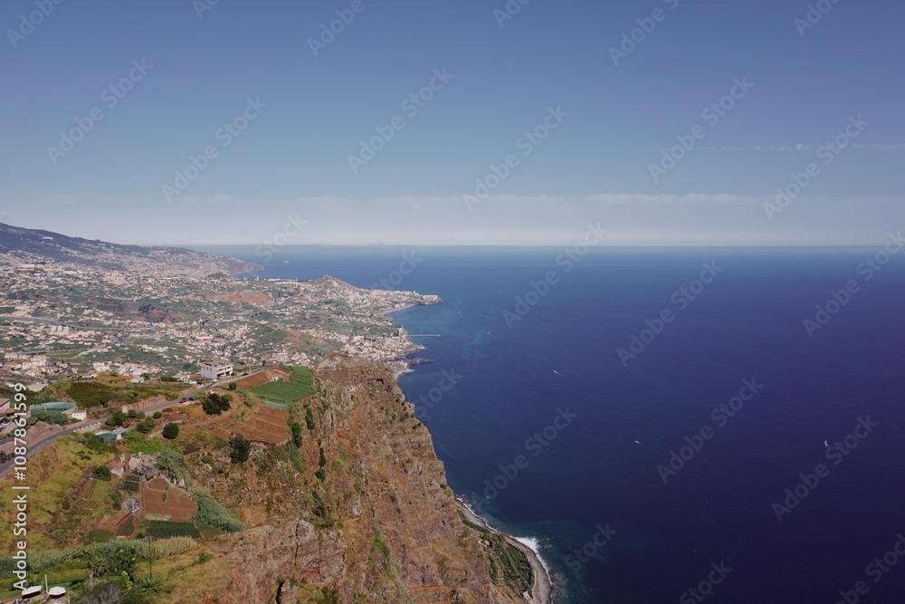 Coastal Cliffside Overlooking the Vast Ocean and Distant Towns Coastal Cliffside Overlooking the Vast Ocean and Distant Towns