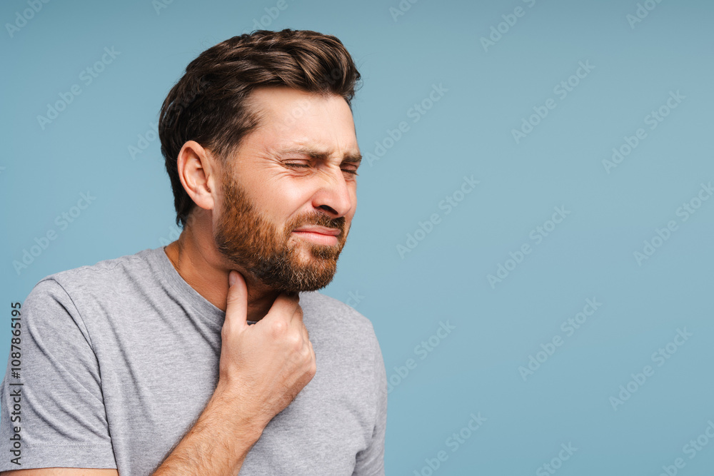 Portrait of sad, bearded, Latin man having sore throat, virus, flu. Treatment, health care concept Portrait of sad, bearded, Latin man having sore throat, virus, flu. Treatment, health care concept