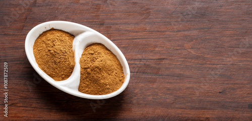 cinnamon chips and powder on rustic wood