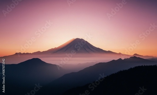Misty mountain landscape at dawn with trees and soft pink sky in the morning ...