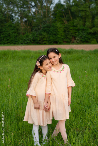 cute little girls sisters holding hands show tenderness and connection of sisters photo