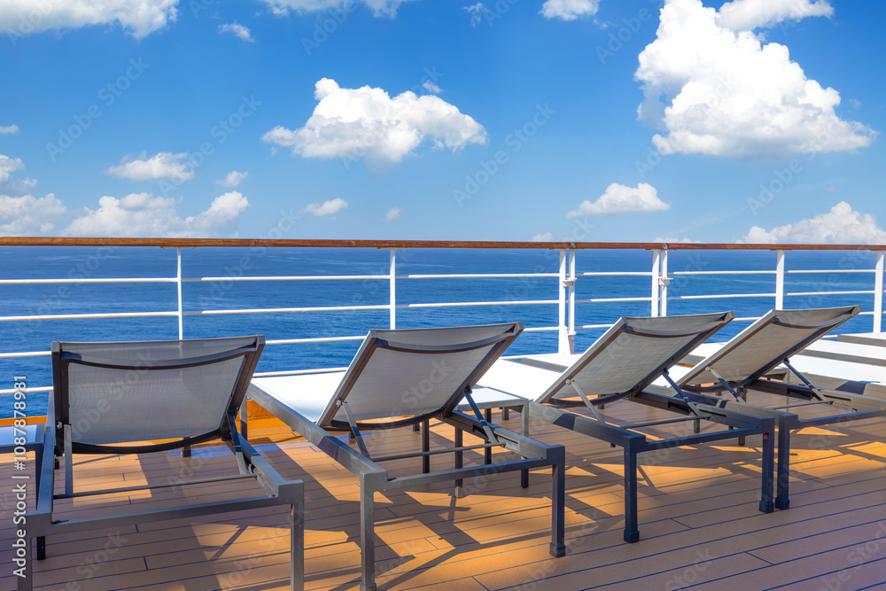 Cruise ship deck and lounge chairs overlooking beautiful ocean on a cruise vacation in Caribbean Cruise ship deck and lounge chairs overlooking beautiful ocean on a cruise vacation in Caribbean