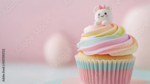 Colorful cupcake with pink frosting and decorative figure on a pastel background