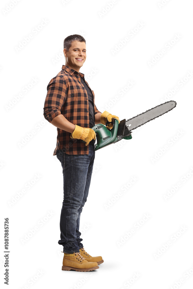 Young male worker holding a chainsaw Young male worker holding a chainsaw