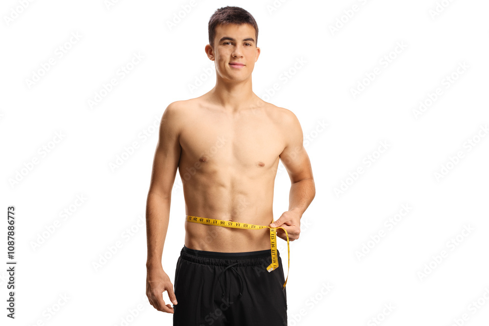 Fototapeta premium Young man with naked torso measuring his waist