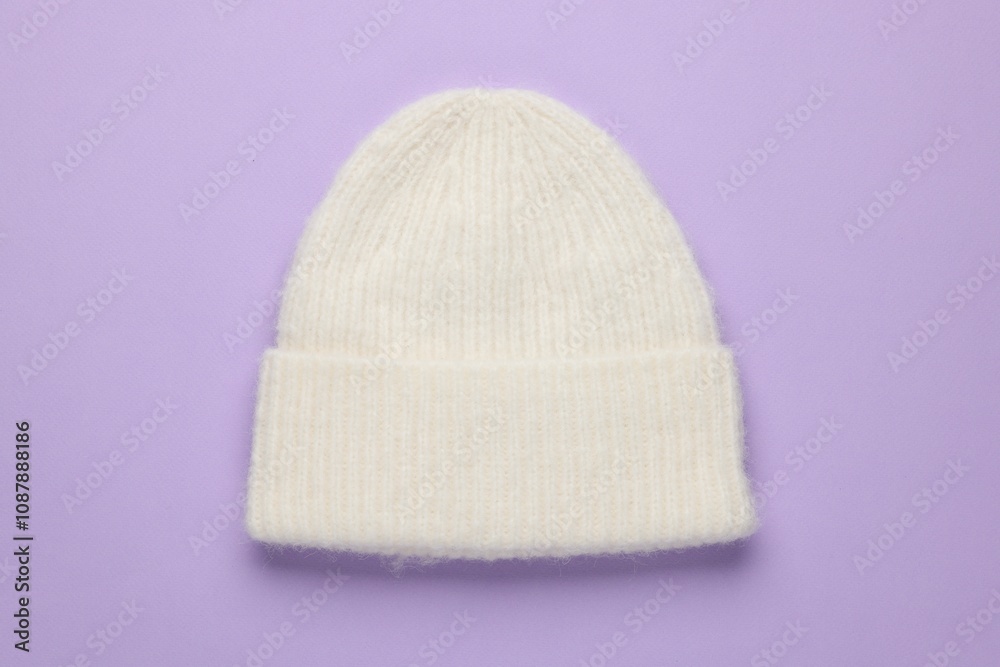 Warm woolen hat on lilac background, top view Warm woolen hat on lilac background, top view
