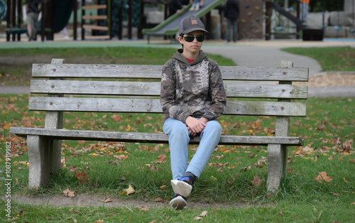 boy in a park  child sitting on bench in park, photo