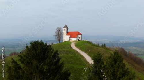 A hill top church of Saint Ana in Slovenia looking over the Ljubljana Barje in the autumn, drone video, drone shot photo