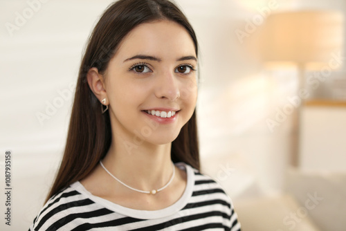 Portrait of smiling teenage girl at home