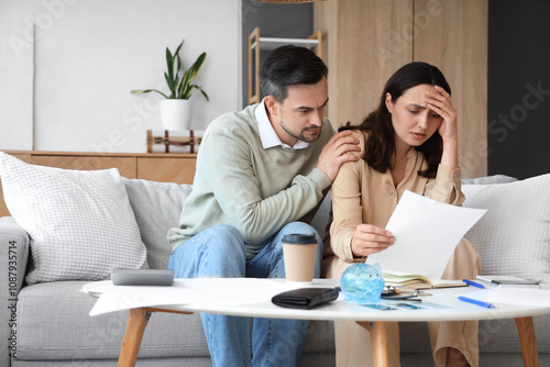 Worried young couple with b...
