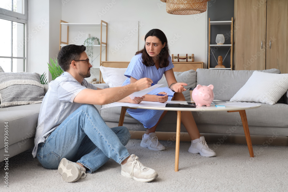 Young couple discussing their debt at home. Bankruptcy concept Young couple discussing their debt at home. Bankruptcy concept