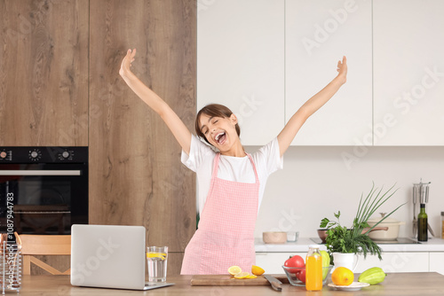 Happy young housewife at ta...