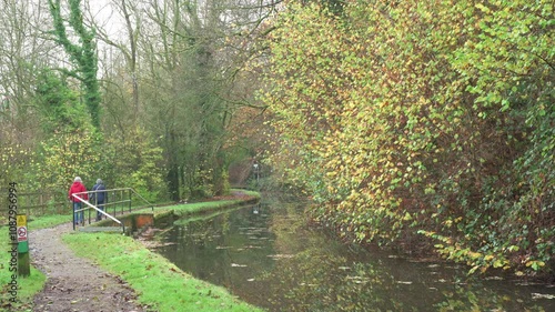 FROGHALL, STAFFORDSHIRE, ENGLAND - NOVEMBER 11 2024: Two elderly women walking along the Caldon canal near Froghall during autumn. photo