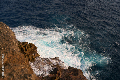 Cinematic aerial landscape shots of the beautiful island of Nusa Penida. Huge cliffs by the shoreline and hidden dream beaches with clear water and foaming wave.