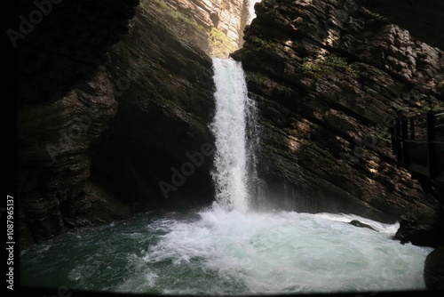 Thur waterfalls cascades into a pool within a rock formation in Wildhaus-Alt St Johann, Switzerland photo