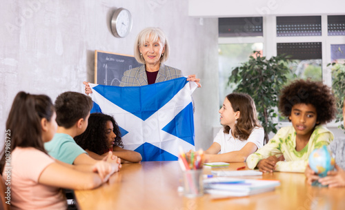 in geography lesson, elderly teacher very eloquently tells children about history of ancient scotland photo