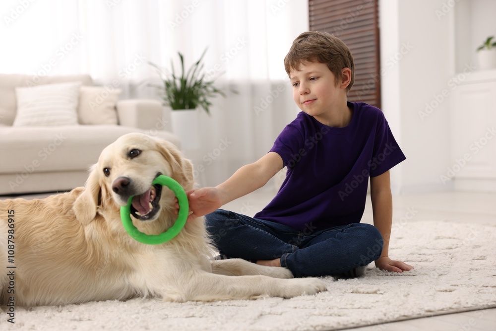 Boy playing with his cute dog at home Boy playing with his cute dog at home