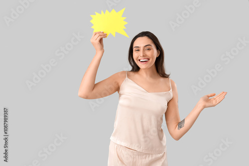 Young woman in pajamas with...