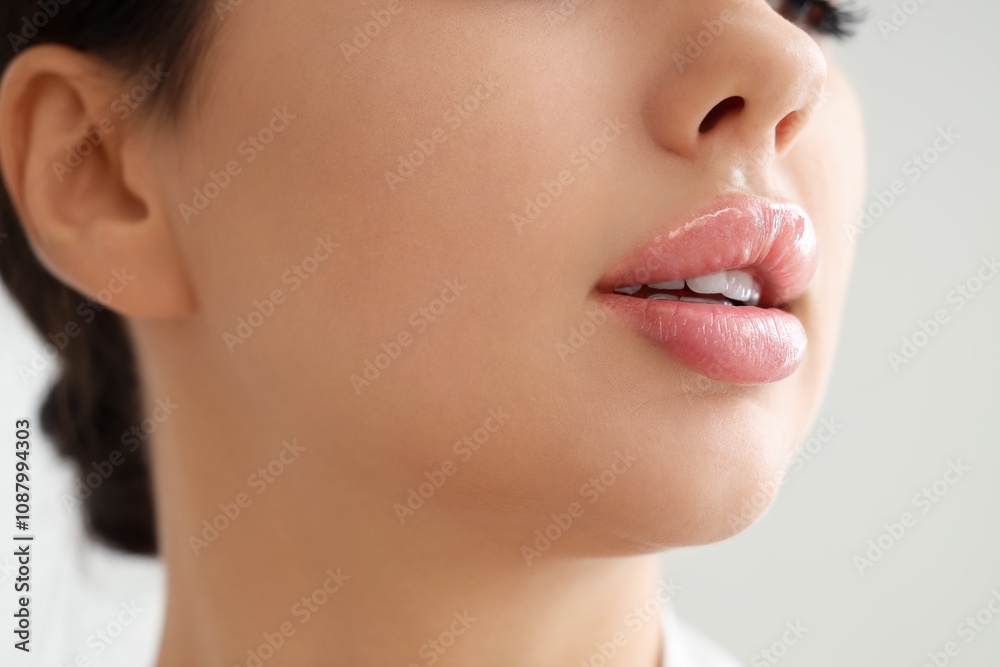 Beautiful young woman with soft lips on light background, closeup Beautiful young woman with soft lips on light background, closeup