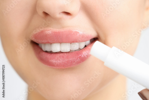 Smiling young woman applyin...