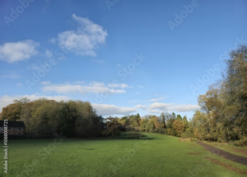 A grassy field with a house in the distance