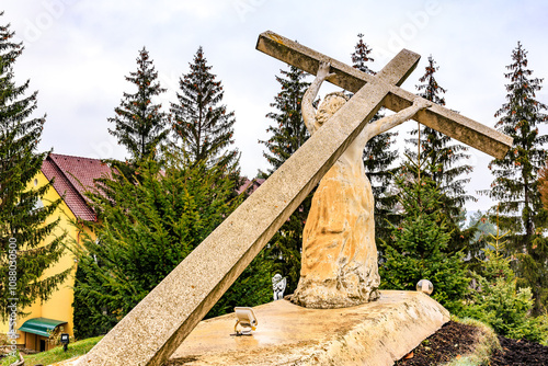 Sculpture Jesus Christ carrying his cross, old monastery Hincu in Moldova. Background with selective focus photo