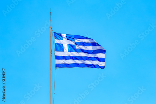 A blue and white flag with a white stripe flying in the air, greek flag of the state of Greece