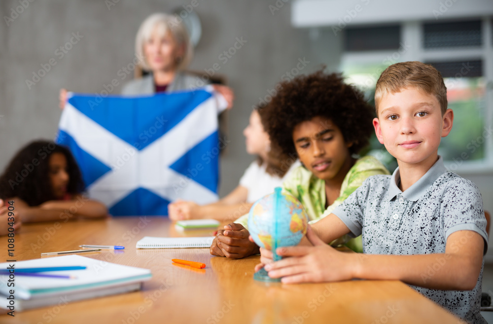 in geography lesson, elderly teacher very eloquently tells children about history of ancient scotland in geography lesson, elderly teacher very eloquently tells children about history of ancient scotland
