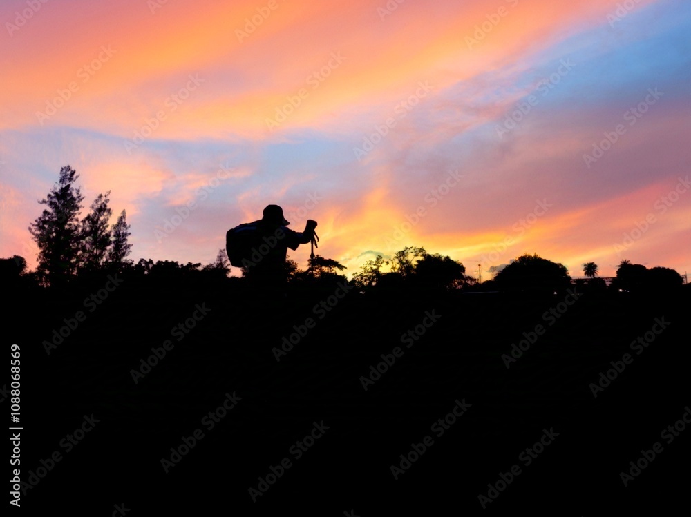 Fototapeta premium “Asian Woman Night Hiking with Lantern in Tropical Forest Adventure sunset