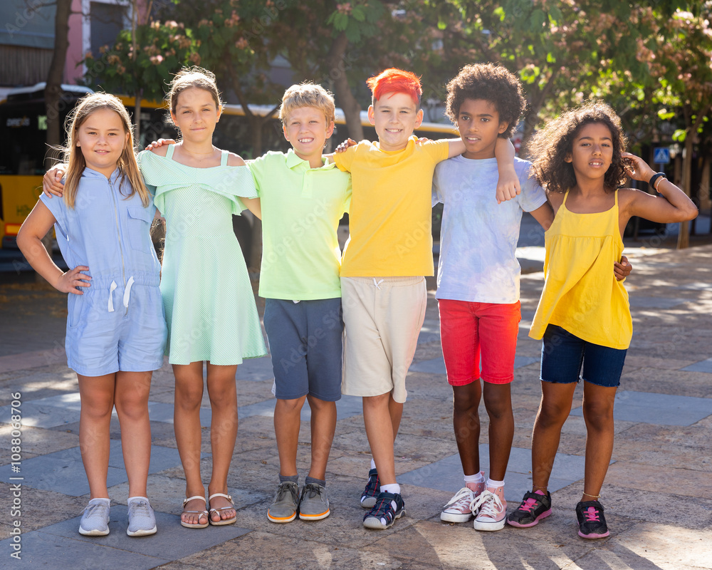 Group photo of friendly multiracial kids standing together outdoors during summer day. Group photo of friendly multiracial kids standing together outdoors during summer day.