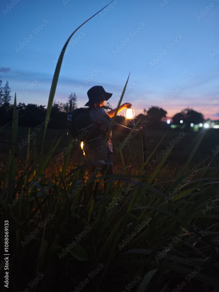 “Asian Woman Night Hiking with Lantern in Tropical Forest Adventure sunset