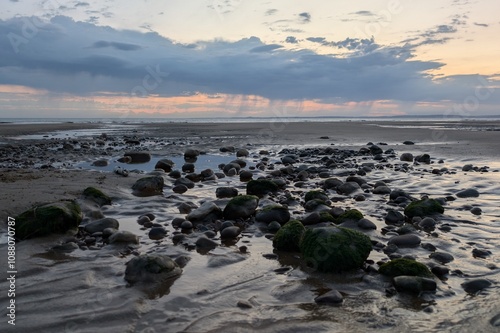 Boulders on sker beach at golden hour photo