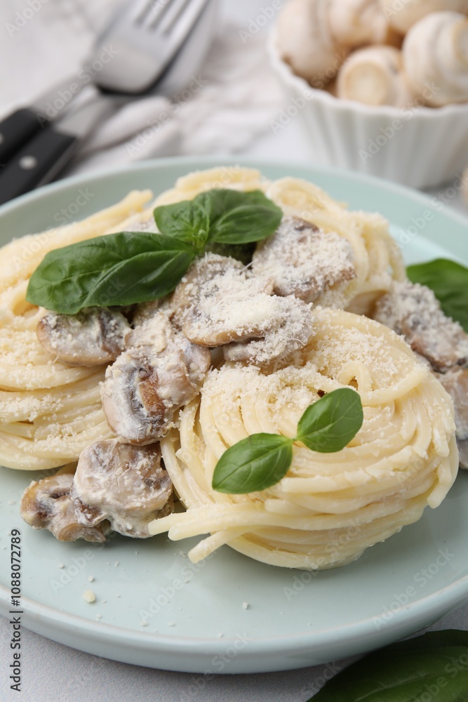 Delicious pasta with mushrooms and basil on table, closeup Delicious pasta with mushrooms and basil on table, closeup