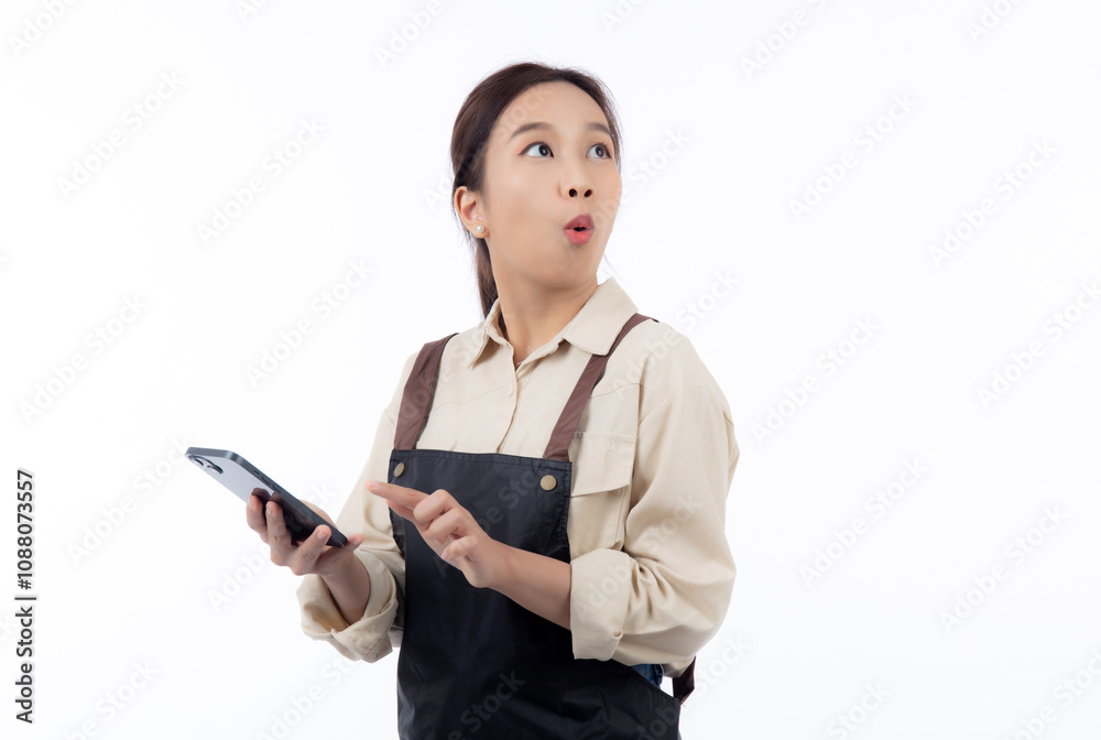 Portrait happy young asian barista woman in apron while looking smart phone gesture surprised isolated white background, waitress or entrepreneur watching smartphone, small business or startup. Portrait happy young asian barista woman in apron while looking smart phone gesture surprised isolated white background, waitress or entrepreneur watching smartphone, small business or startup.