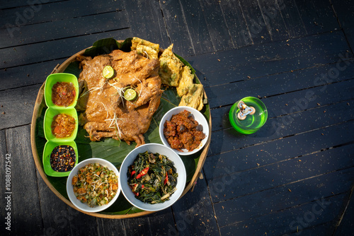 Ingkung Ayam, a traditional food from Yogyakarta, Indonesia, made from a whole chicken boiled with spice photo