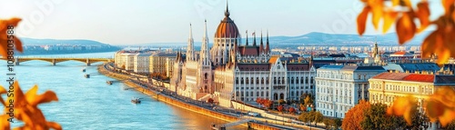 Wallpaper Mural A picturesque view of Budapest's Parliament building alongside the Danube River, framed by vibrant autumn foliage. Torontodigital.ca