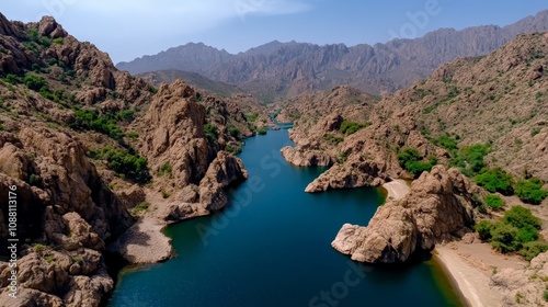 Serene Mountain Lake: A breathtaking aerial view captures a tranquil lake nestled amidst rugged mountains, showcasing the beauty of nature's artistry and the tranquility of secluded landscapes. 