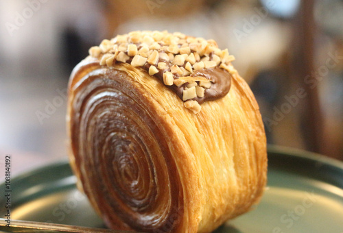 timbering nutella croissant with nuts on plate. photo