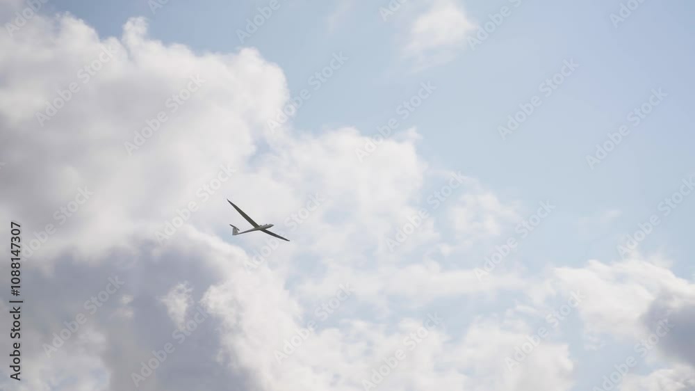 A sailplane glides over the Swiss Alps