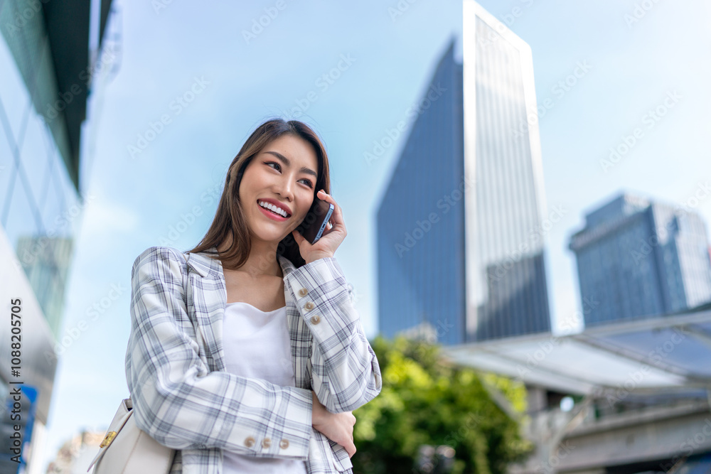 Asian Businesswoman Using Phone In Front of Cityscape Background Asian Businesswoman Using Phone In Front of Cityscape Background