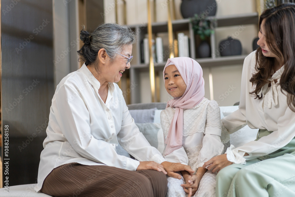 Obraz premium Multi generational asian family bonding at home, grandmother, mother, and daughter play together, happy family moments, diverse family values, joyful connection, smiling and warmth, candid lifestyle