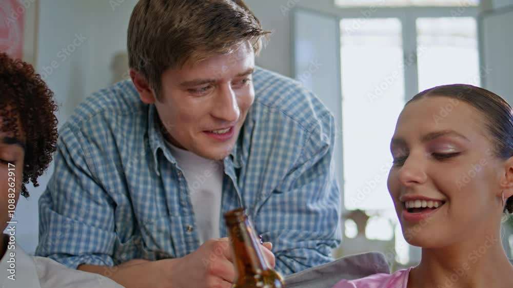 Resting people gathering home together closeup. Smiling friends drinking beer Resting people gathering home together closeup. Smiling friends drinking beer