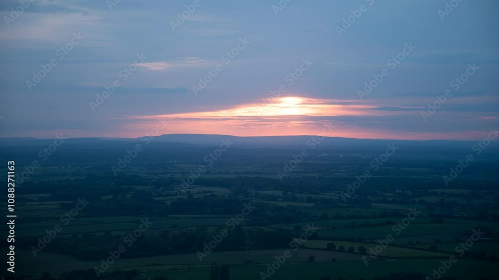 Sun Peaking Through Clouds at Sunset over Countryside in England - Timelapse Sun Peaking Through Clouds at Sunset over Countryside in England - Timelapse