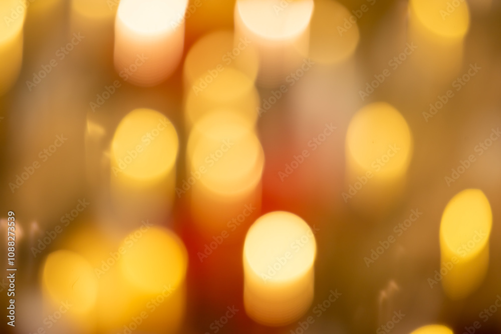 The image is a blurry, yellowish-orange background with many small The image is a blurry, yellowish-orange background with many small